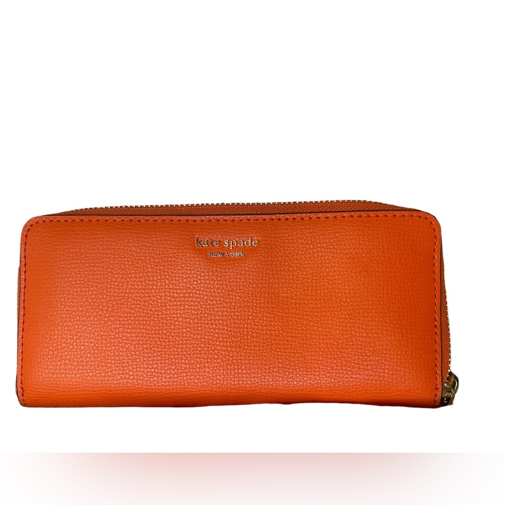 Kate Spade orange wallet. Excellent condition. Almost new. 7 1/2 x 3-3/4 appx.